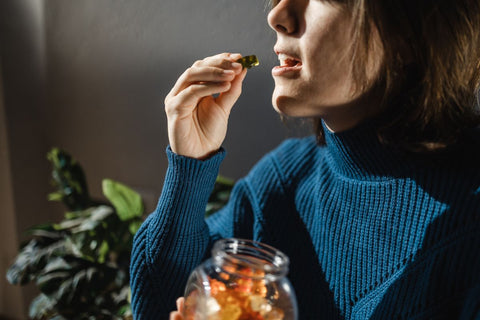 Woman eating edibles weed candy leaf for anxiety alternative treatment