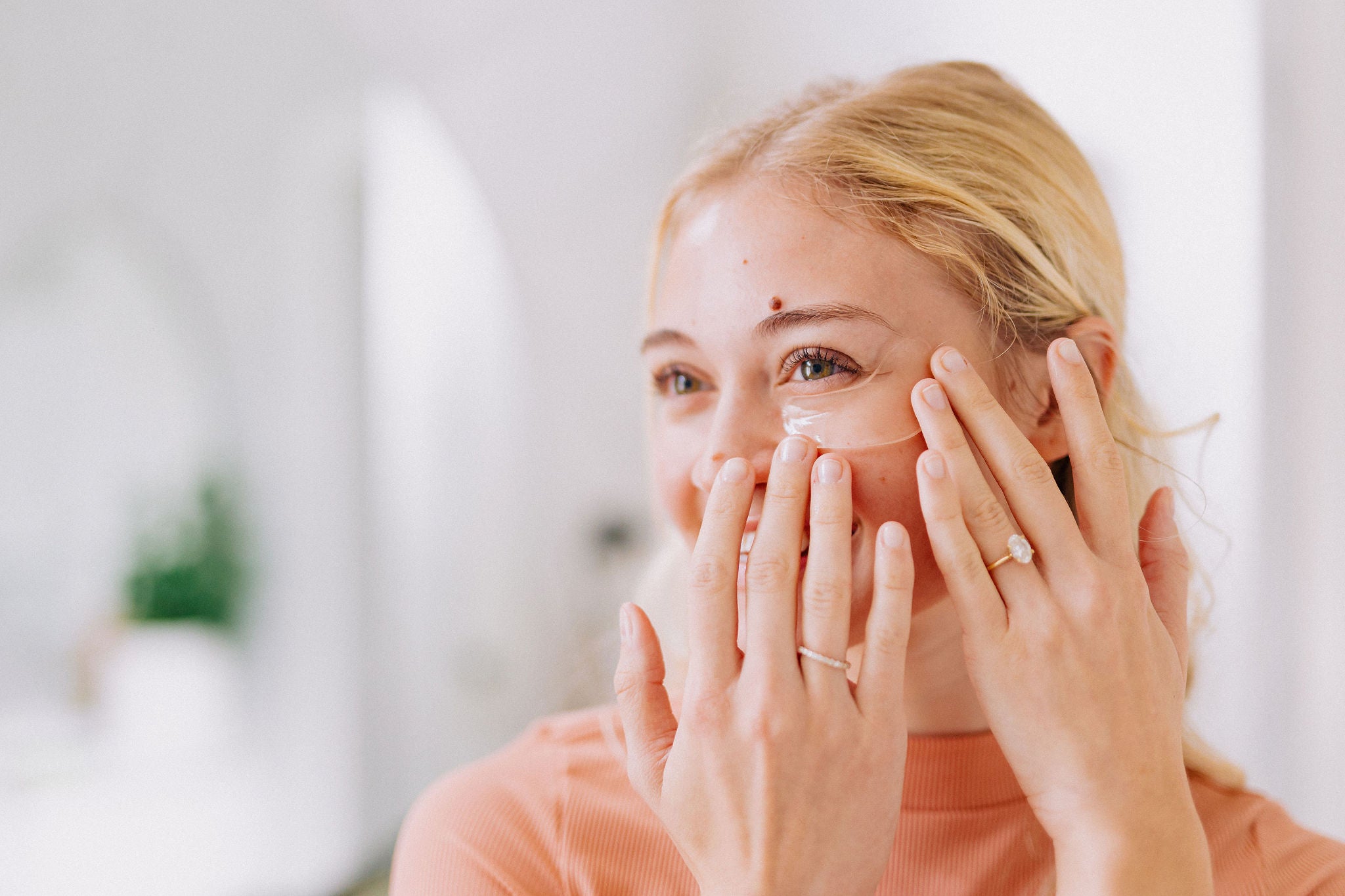 woman putting on under eye gels