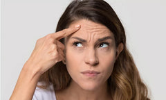 woman pointing to wrinkled forehead