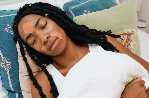 woman sleeping with frownies facial patches on smile lines around the mouth and forehead
