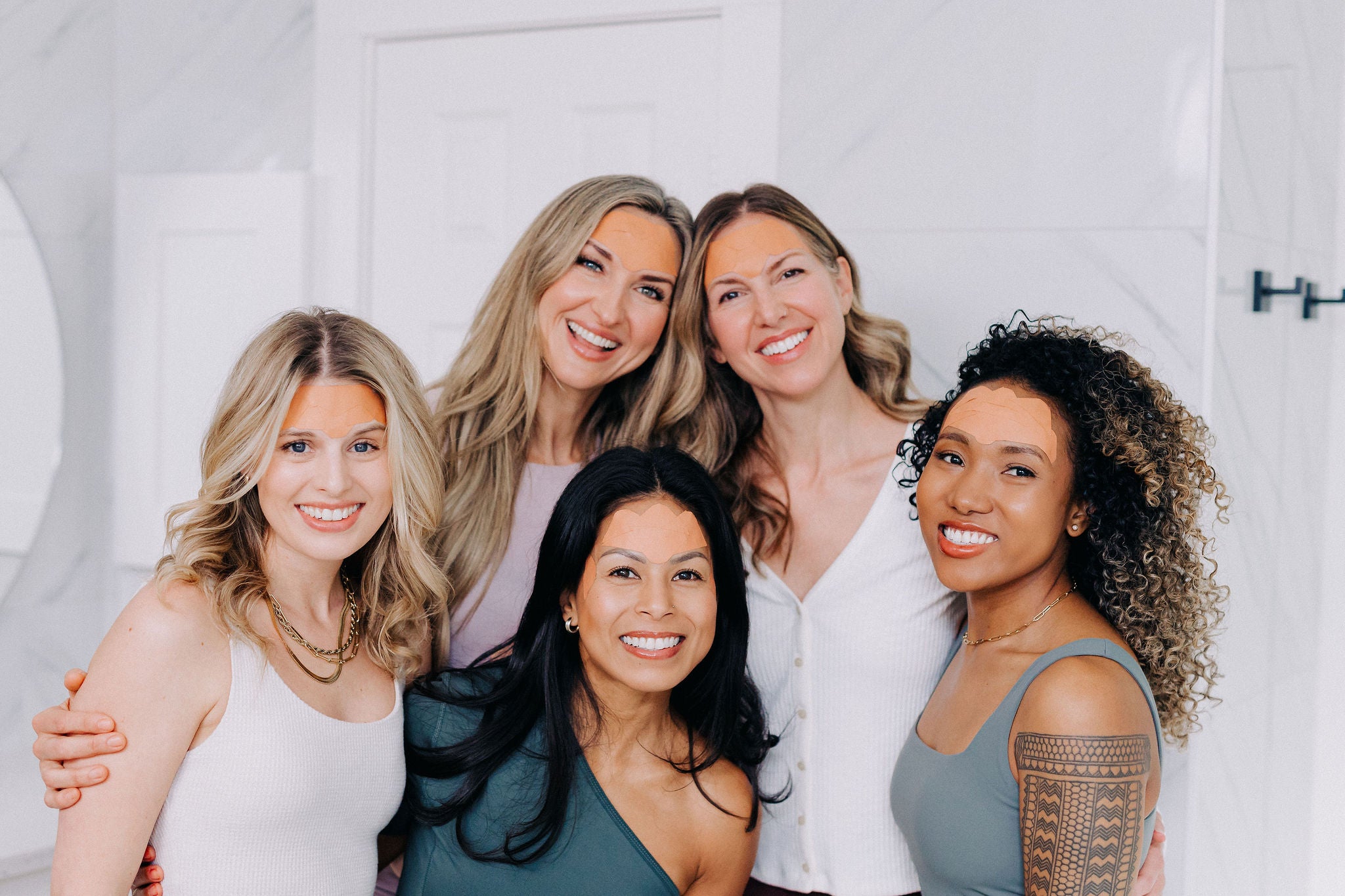 group of 5 women wearing wrinkle patches on their foreheads