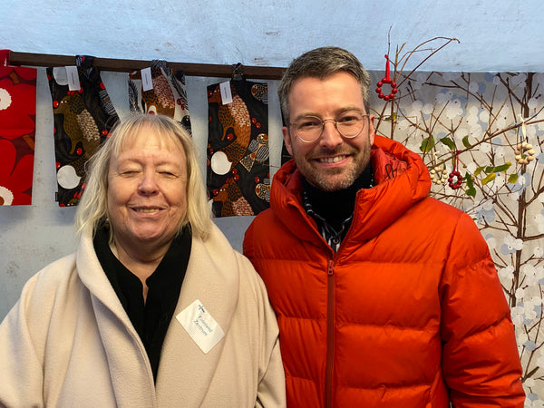 Raija Pannwitz-Kallioniemi, die Vorsitzende des Finnland-Zentrums und Torben Pahl, Inhaber von HARTOG Berlin auf dem finnischen Advents-Basar am HARTOG-Stand