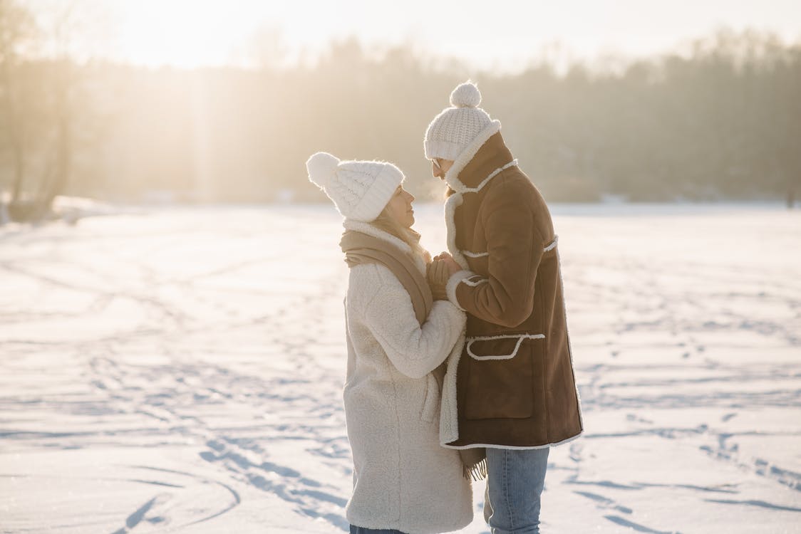 couple gazing at each other in the snow