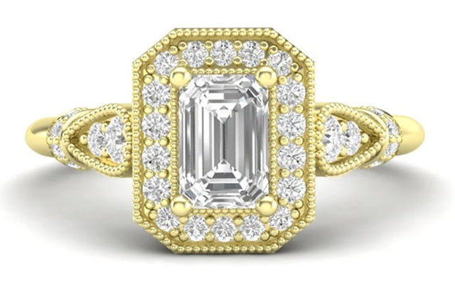 A yellow gold and emerald cut diamond ring