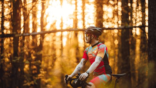 A man with his bicycle and wearing a cycling kit and cycling jersey