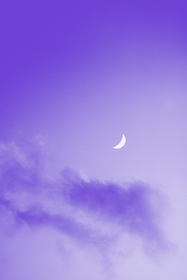 Photograph of a mystical full moon shining in a violet night sky