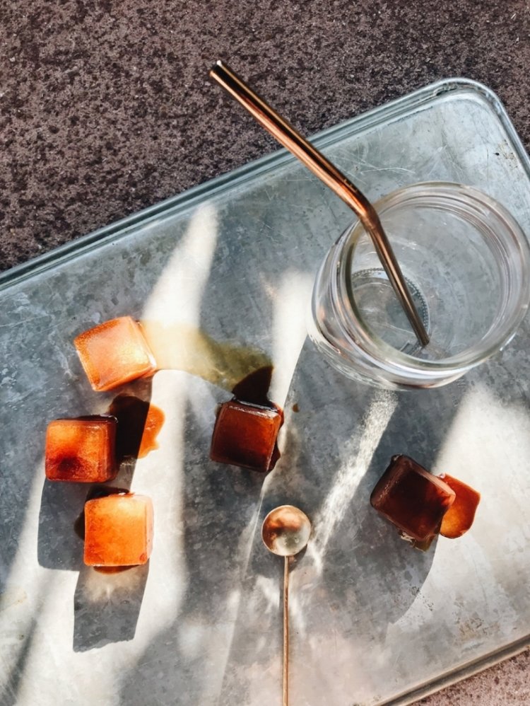 Big Heart Tea Co.'s Fake Coffee ice cubes with reusable straw, reusable cup, and golden reusable spoon