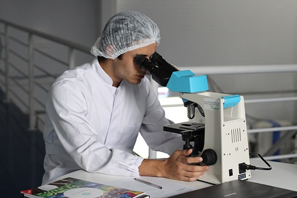 Image of researcher looking into a magnifier