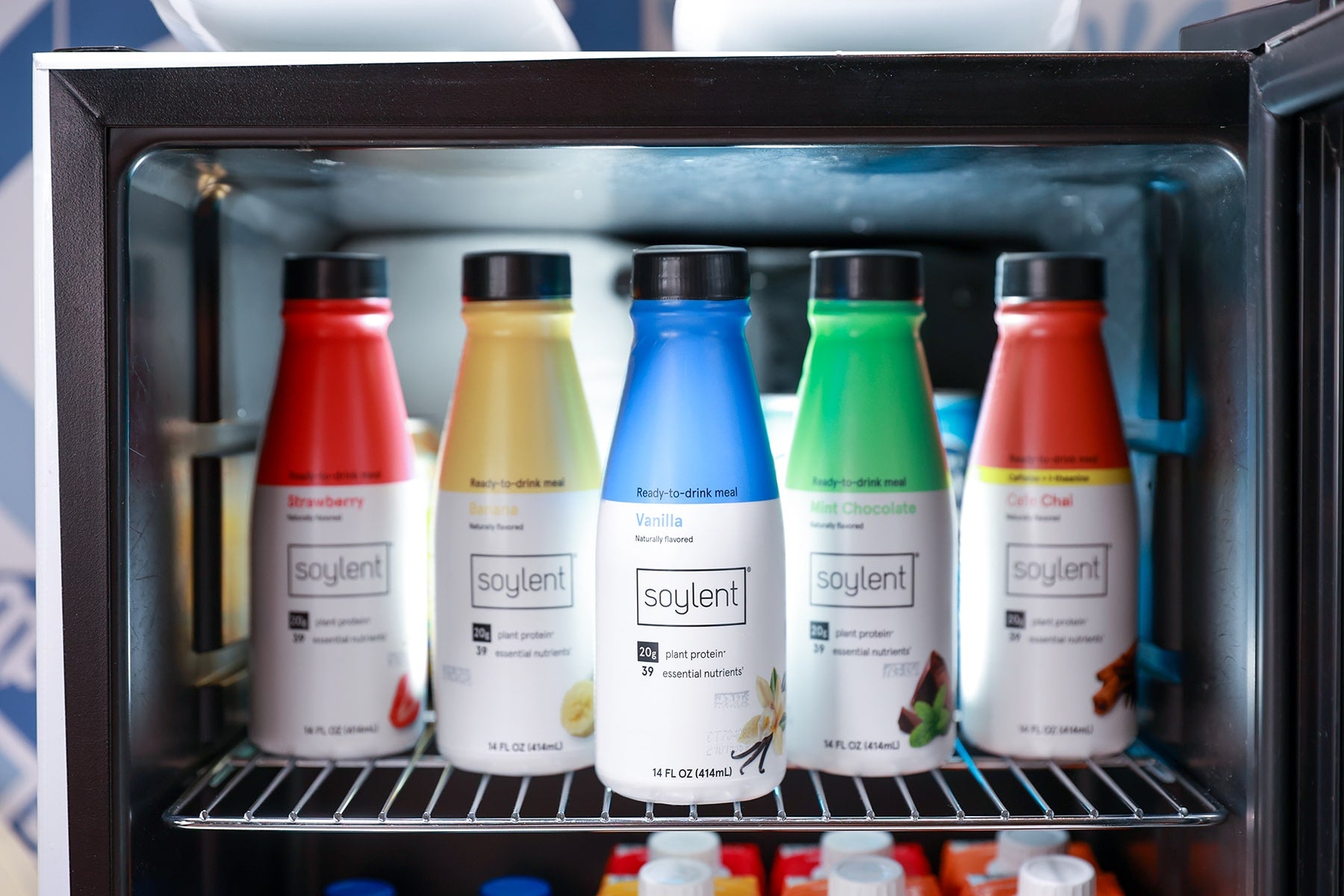 Image of various Soylent bottles and flavors in a fridge