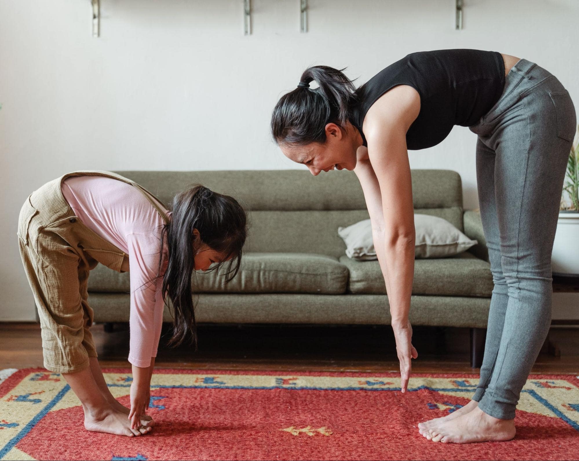 adult and child bending down to touch their toes