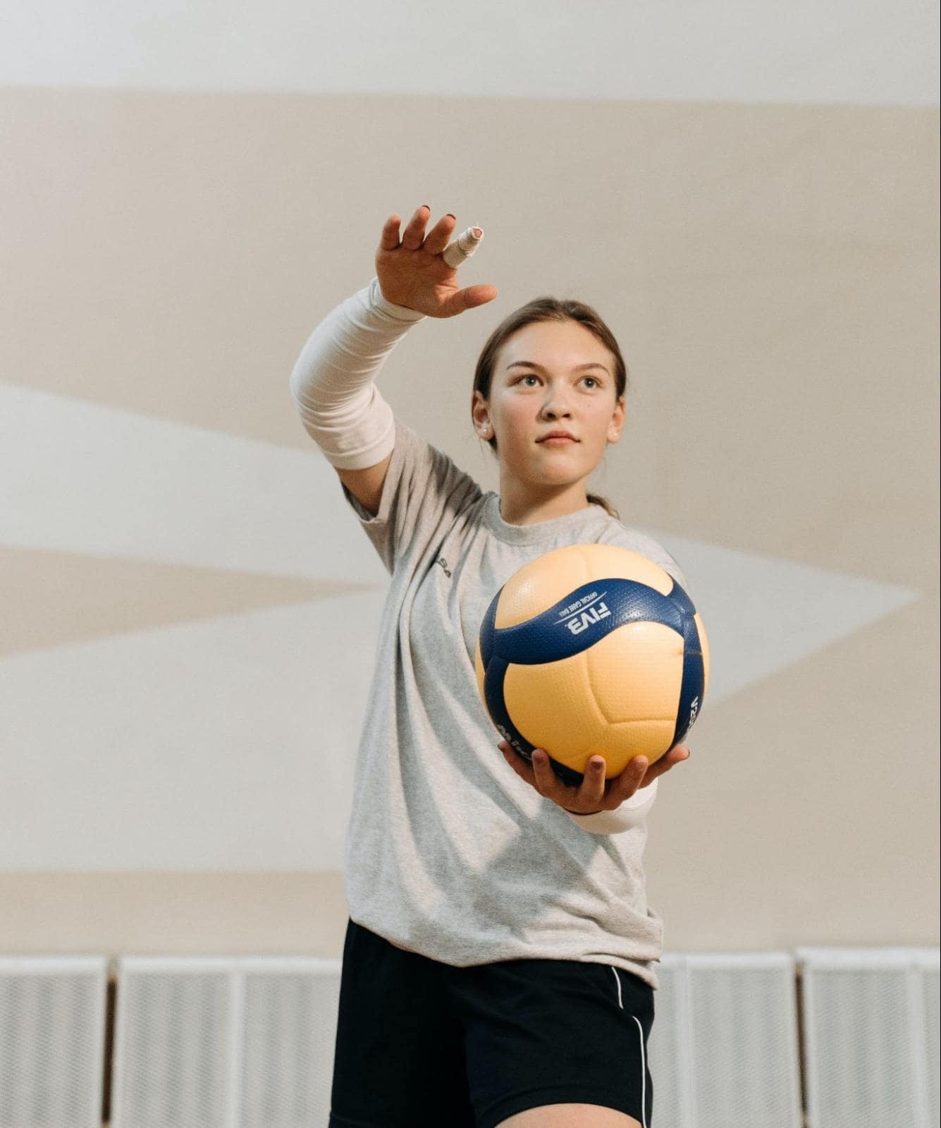 Person serving a volleyball