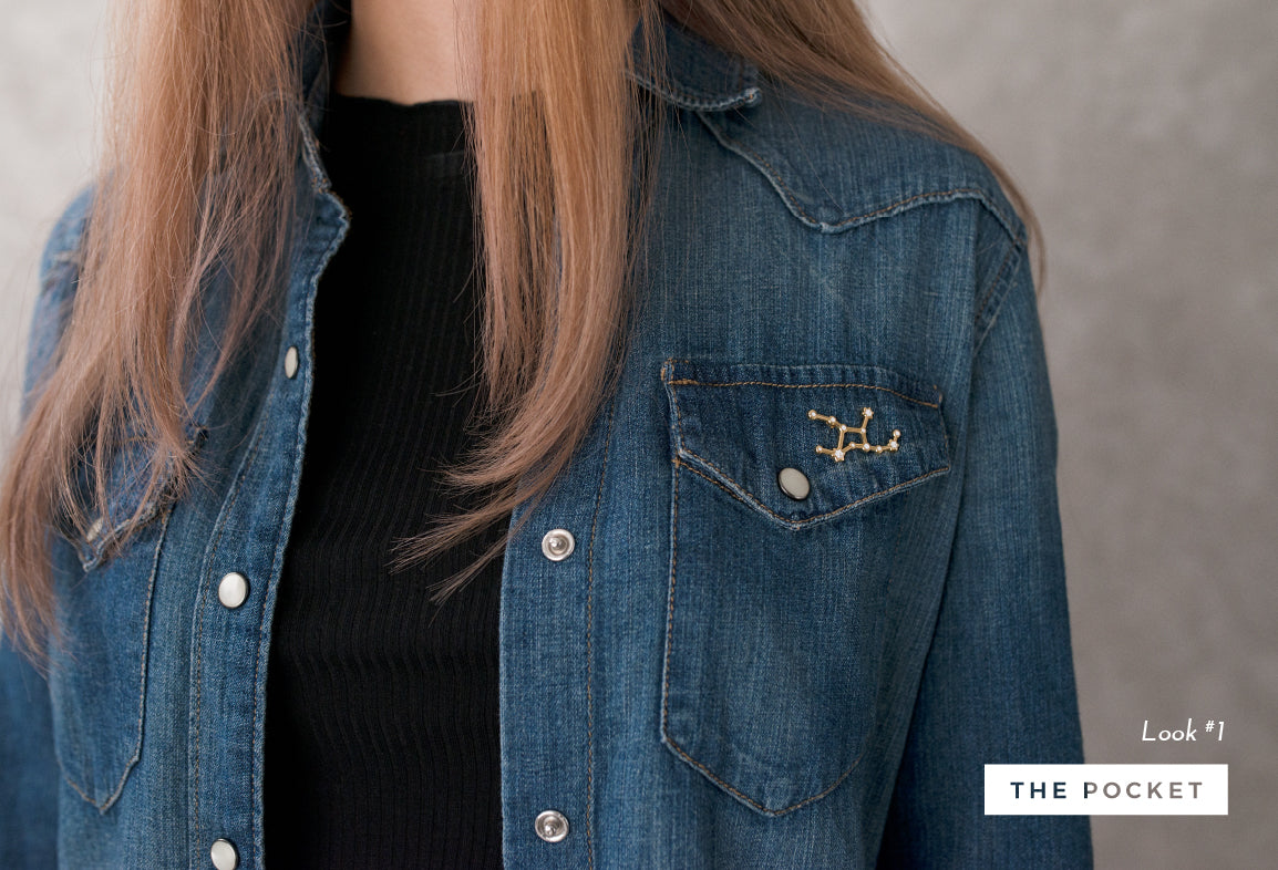 Gold enamel pin on denim pocket