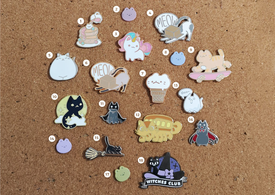 cat enamel pins collection on pin board