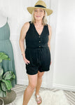 Black romper with button front. Romper features front functional button closure and rope tie at waist. 