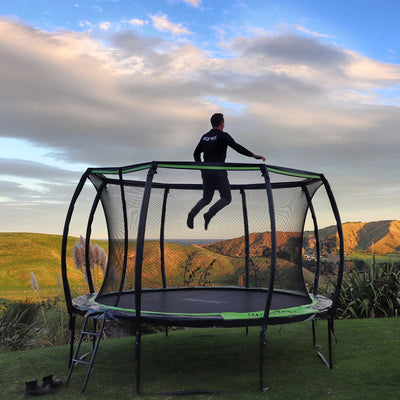 An adult jumping on Jumpflex's 12 ft Trampoline.