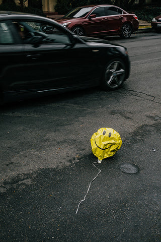 smiley balloon on road