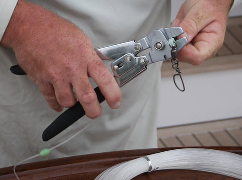 Fisherman using crimper to make fishing rig