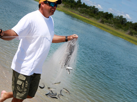 Cast net filled with live baitfish