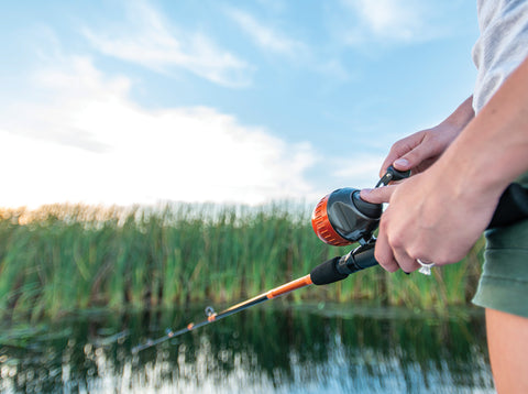 Fishing with rod and reel combo on pond