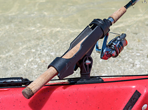 Spinning rod and reel secured in a kayak fishing rod holder