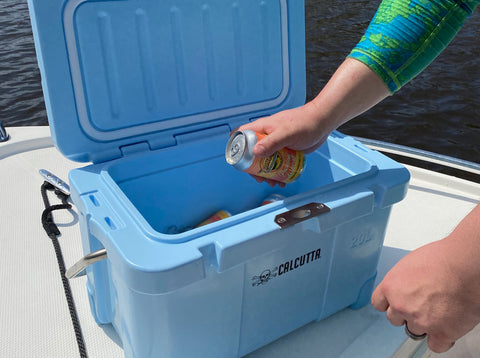 Grabbing a cold drink from a Calcutta cooler