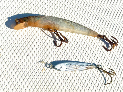 Old fishing lures with rusty, bent hooks