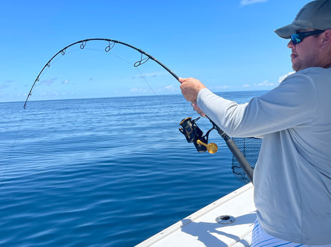 Fisherman fighting a large fish with a Star Rods jigging rod