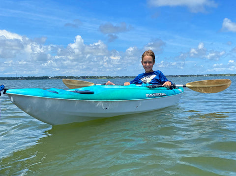 Youth paddler relaxing on a kayak