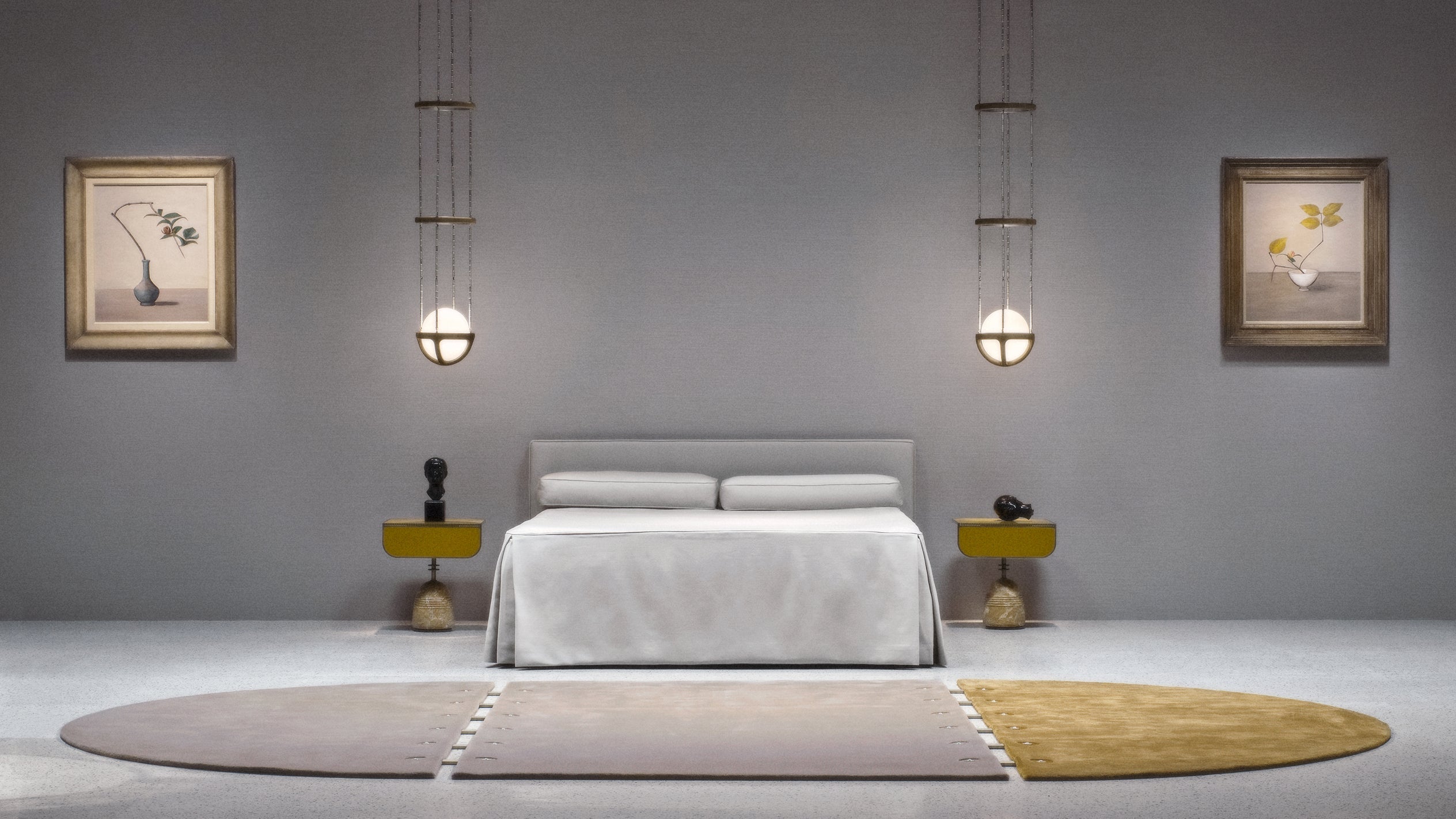 A SEQUENCE modular rug in front of a bed with two REPRISE ceiling pendants hanging either side. 