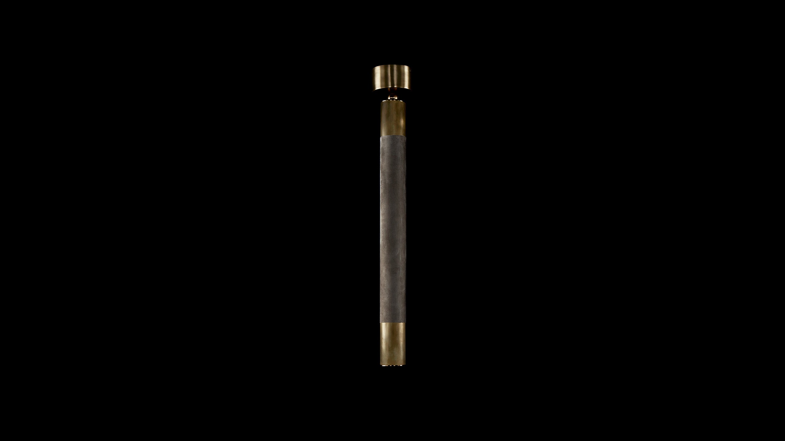 CYLINDER ceiling pendant in Aged Brass and Taupe Leather, against a black background. 