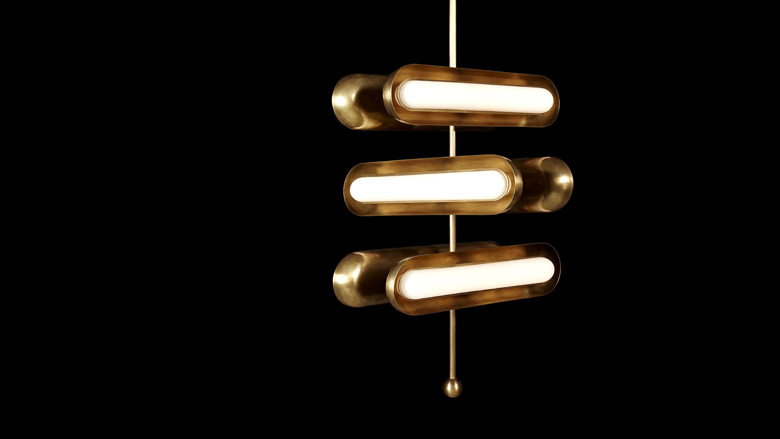 CIRCUIT : 6 ceiling pendant in Aged Brass finish, hanging against a black background. 