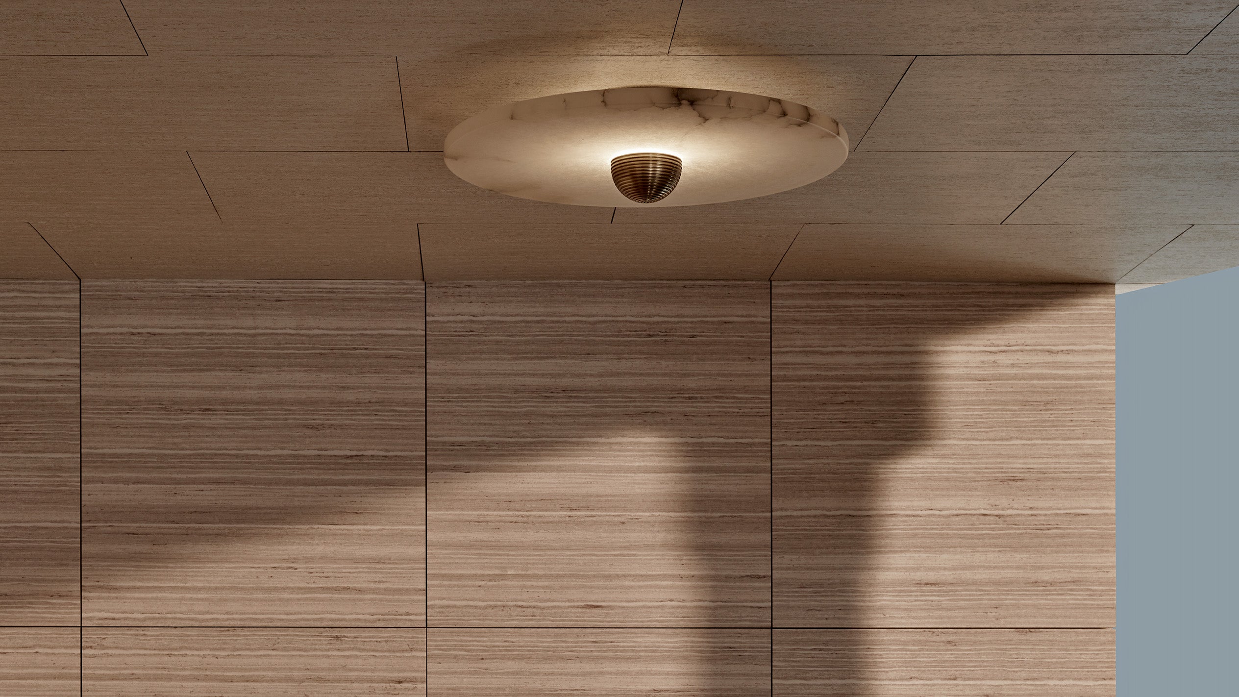 An illuminated MEDIAN : 1 surface light in Aged Brass finish mounted to a ceiling.