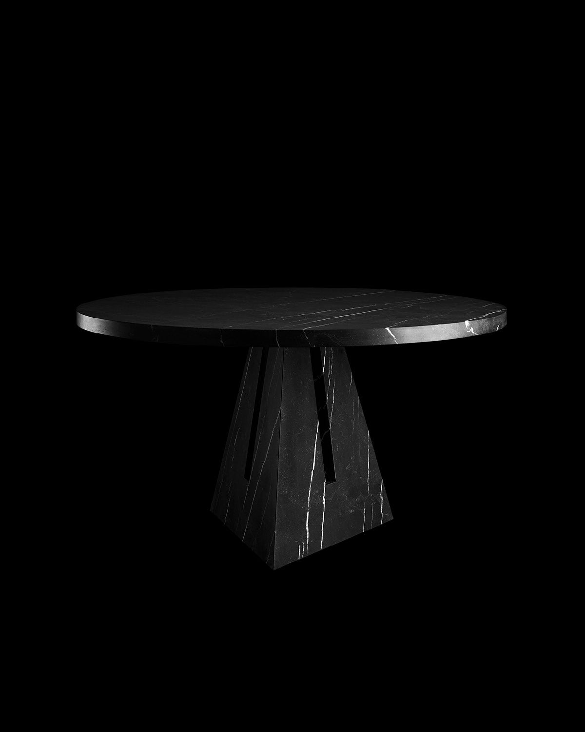 PORTAL circular dining table in Nero Kinitra marble, against a black background. 