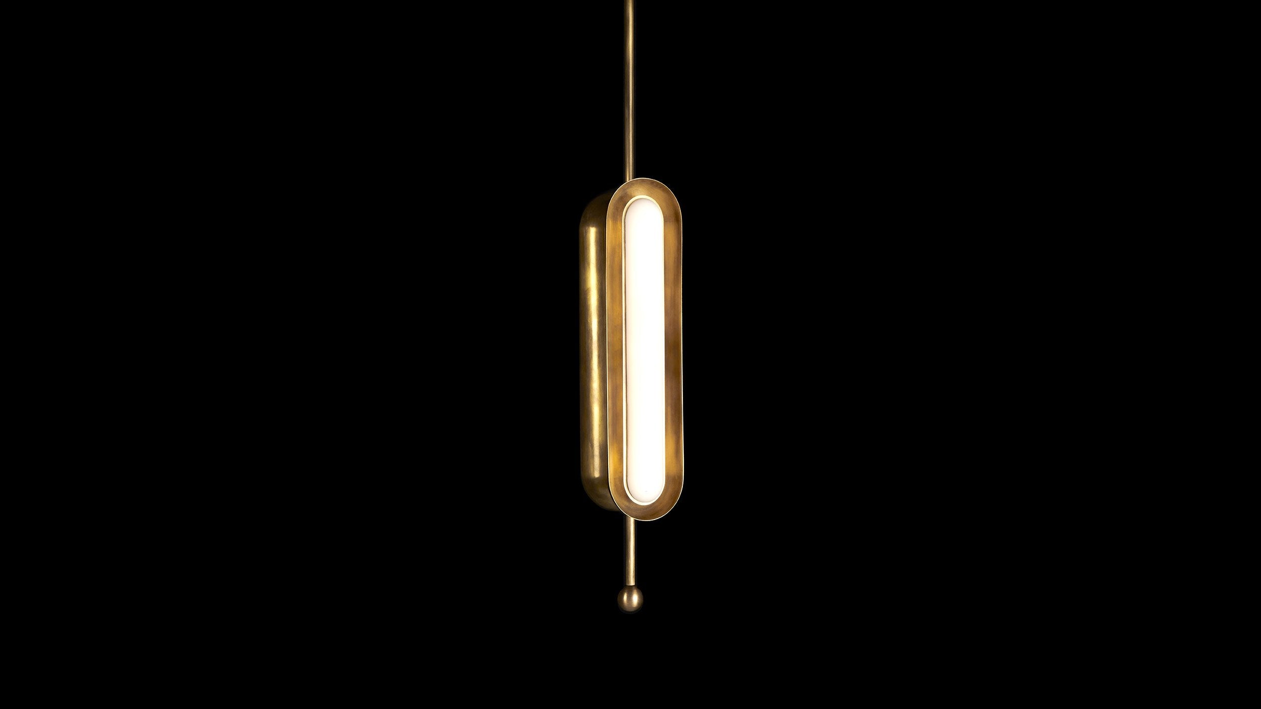 CIRCUIT : 2 vertical ceiling pendant in Aged Brass finish, hanging against a black background. 