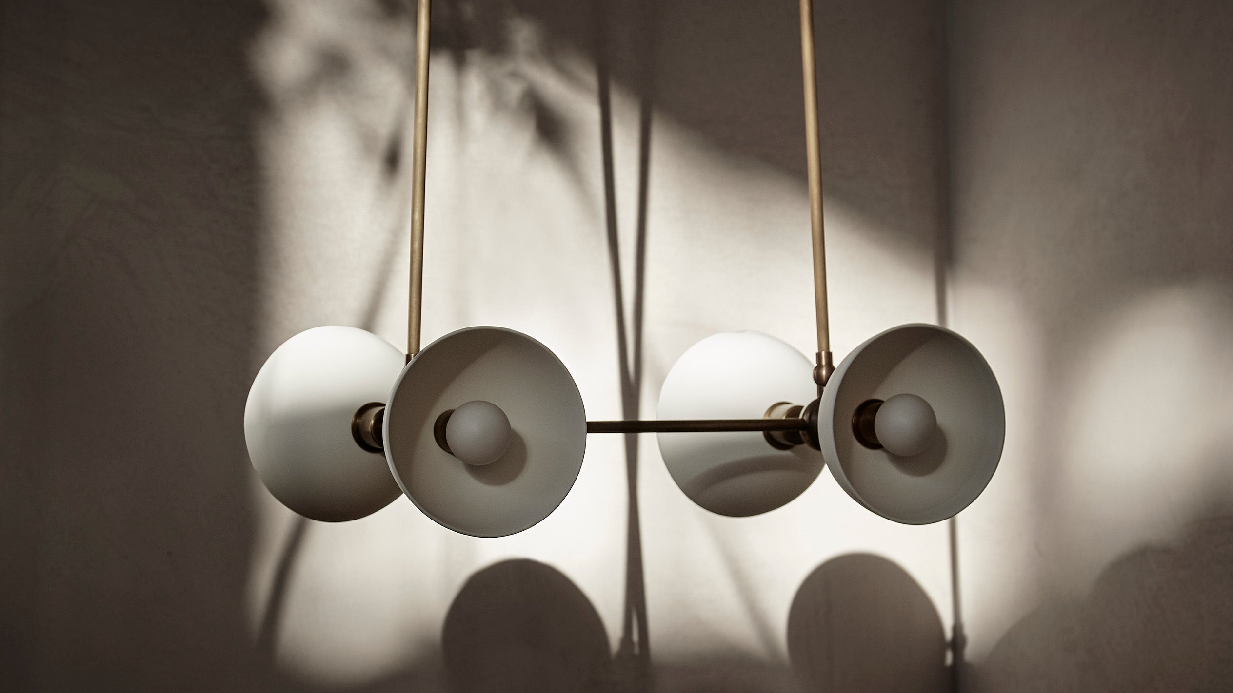 TRAPEZE : 4 ceiling pendant in Aged Brass finish with Porcelain bowls.