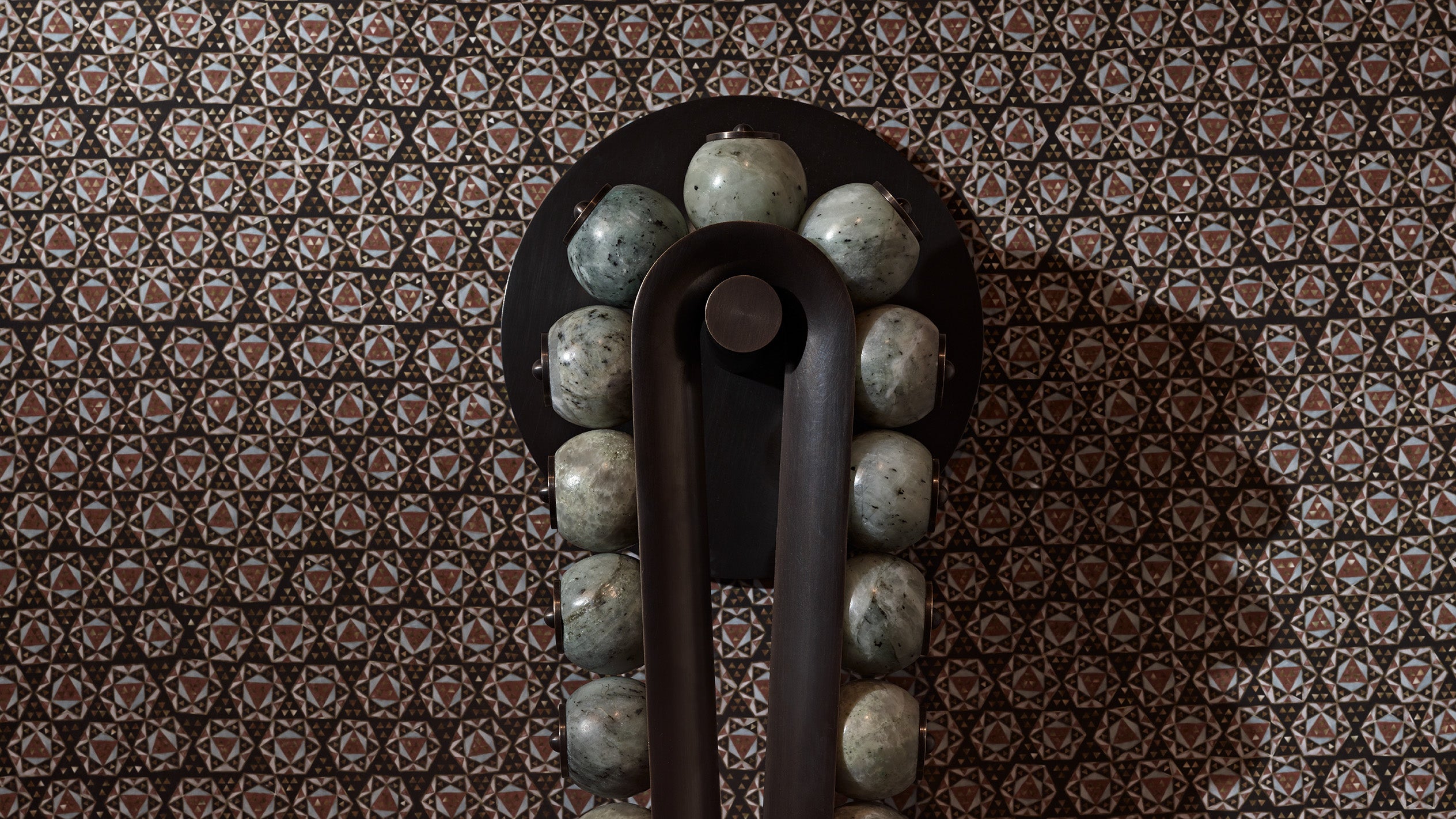 Close up of a TALISMAN : LOOP sconce showing details of the Tarnished Silver finish and Jade stone. 