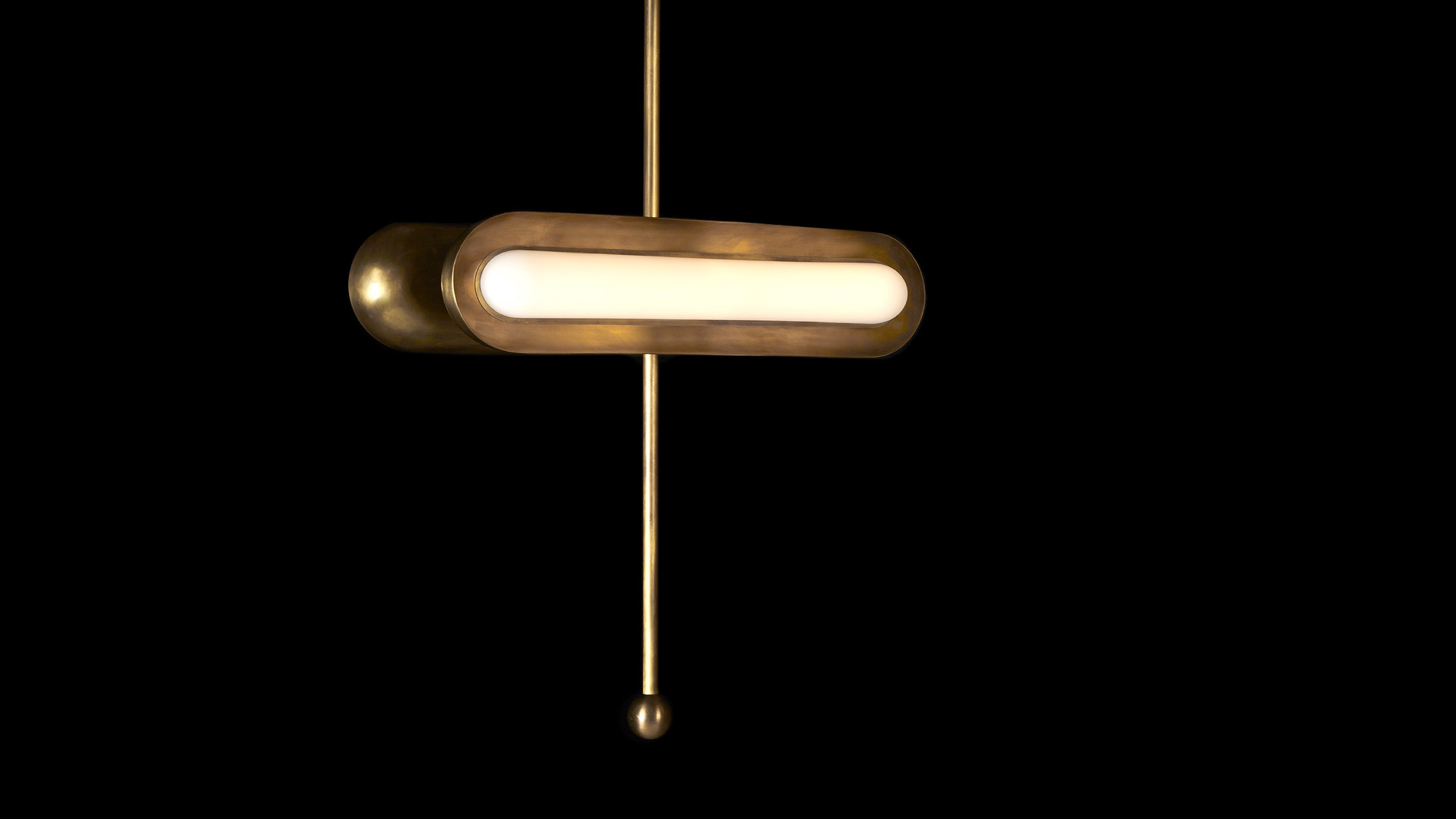 CIRCUIT : 2 horizontal ceiling pendant in Aged Brass finish, hanging against a black background. 