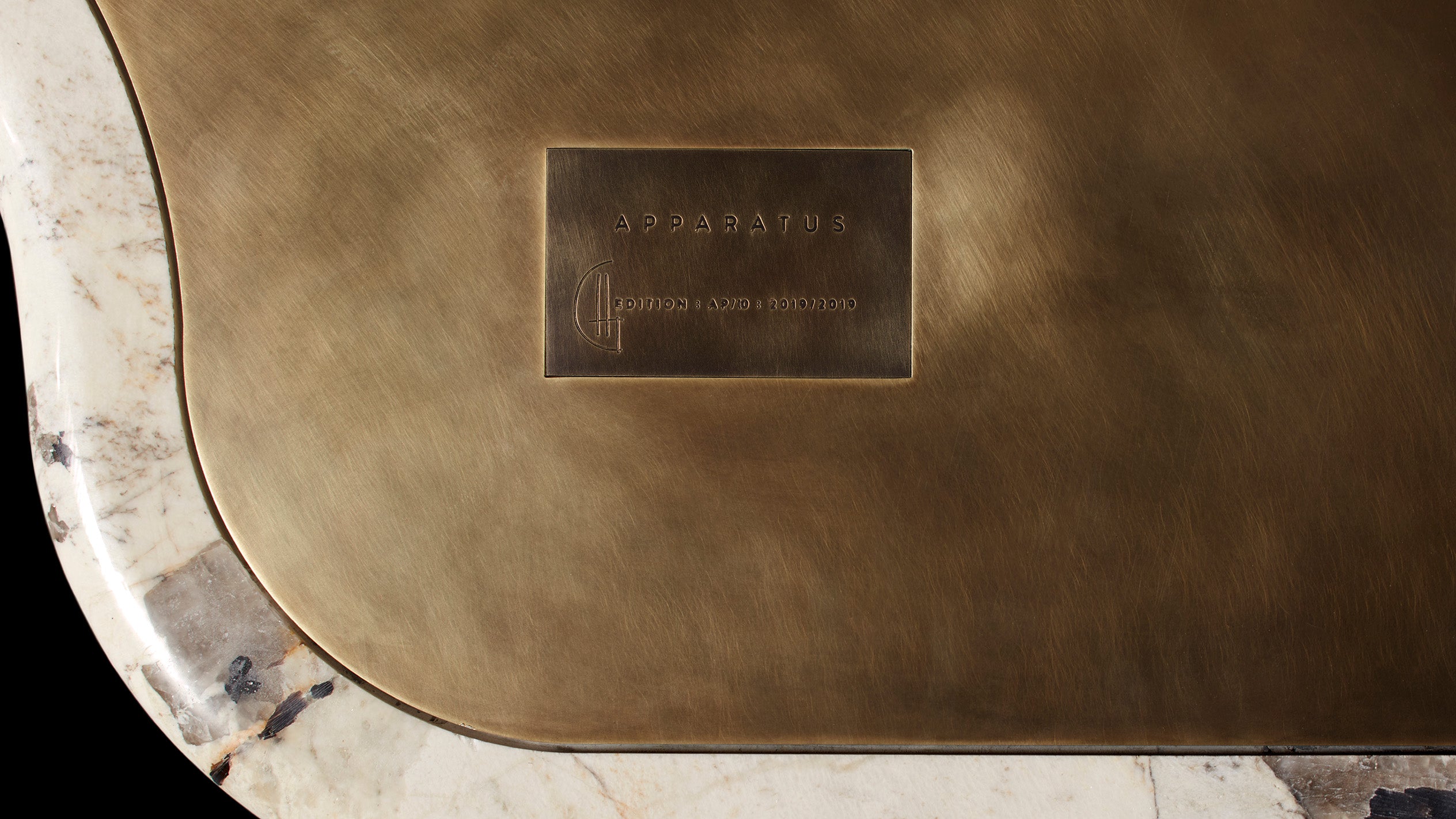 APPARATUS logo on the INTERLUDE marble table. 