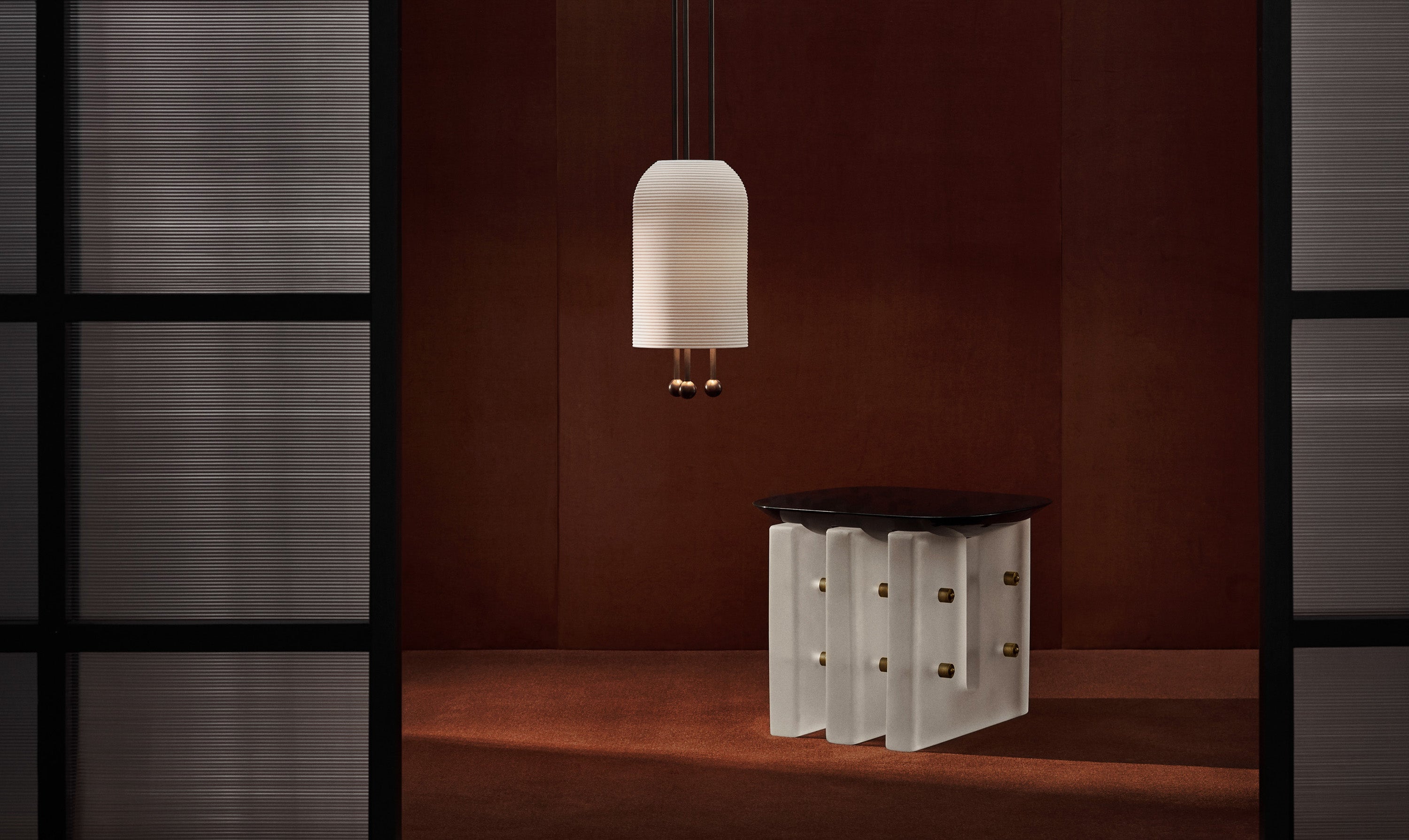 SEGMENT side table in Black Lacquer with a LANTERN ceiling pendant hanging overhead.