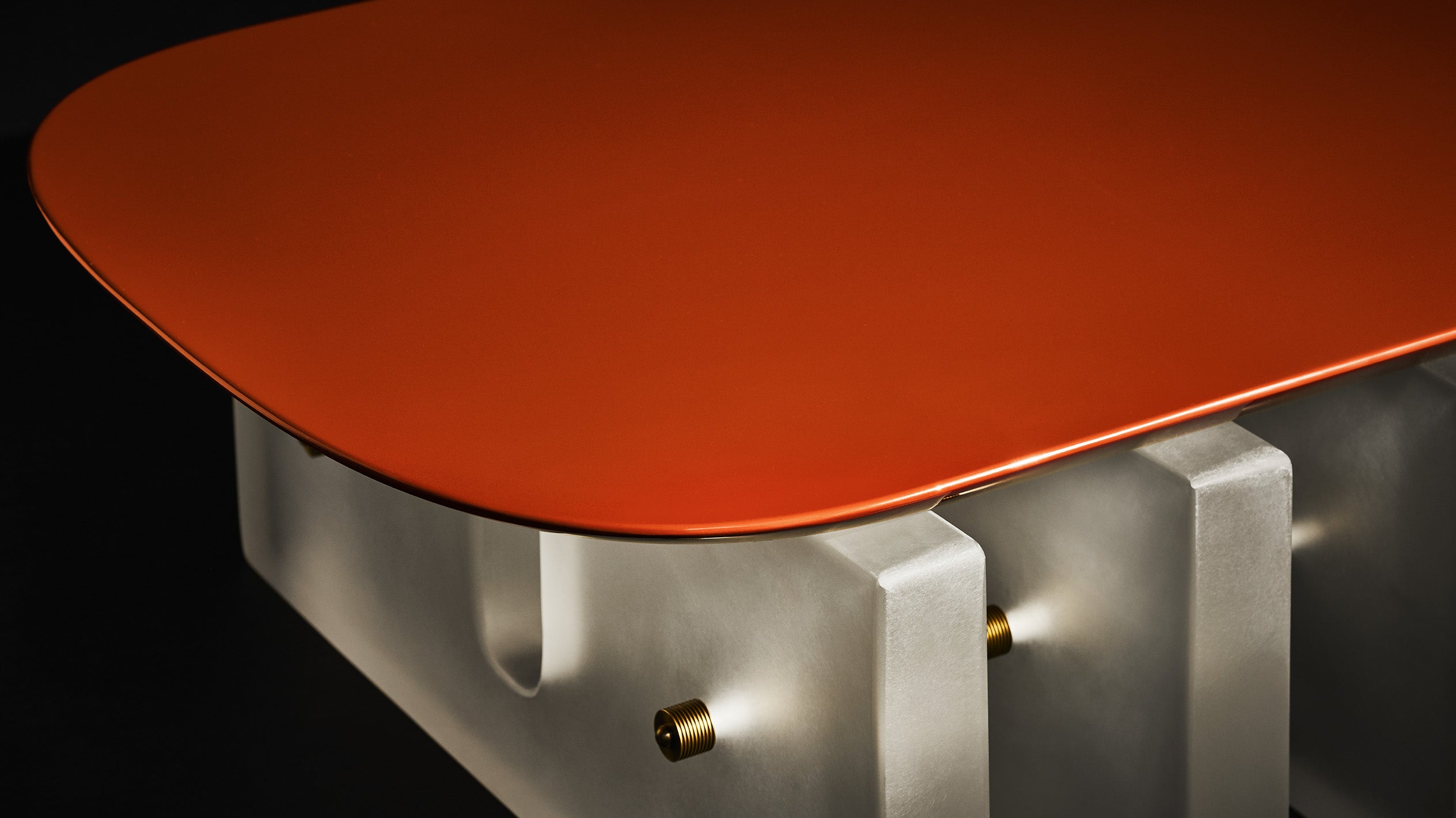 Close up of a SEGMENT coffee table showing details of the Cinnabar lacquer. 