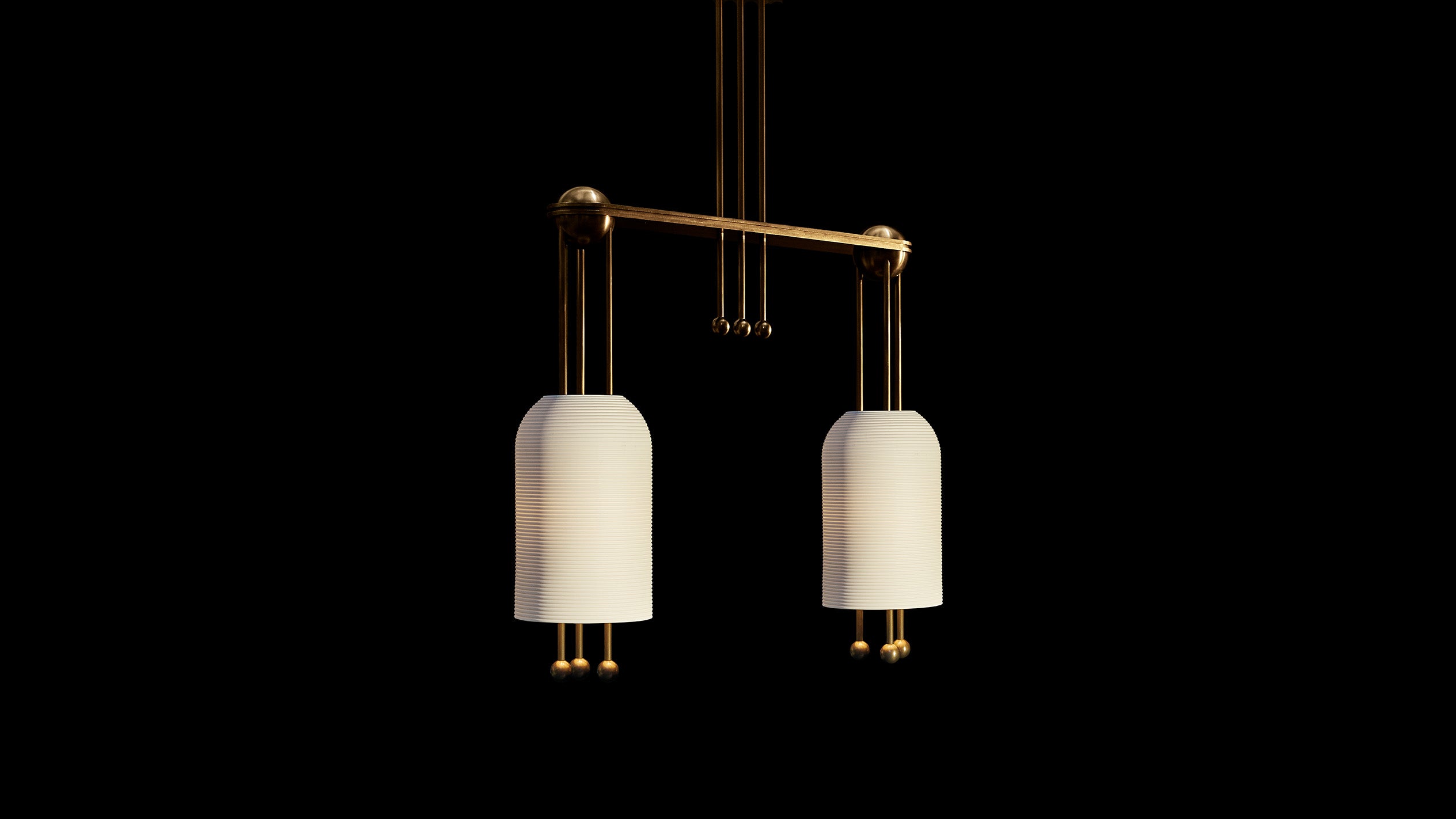 LANTERN : 2 ceiling pendant in Aged Brass finish hanging against a black background. 