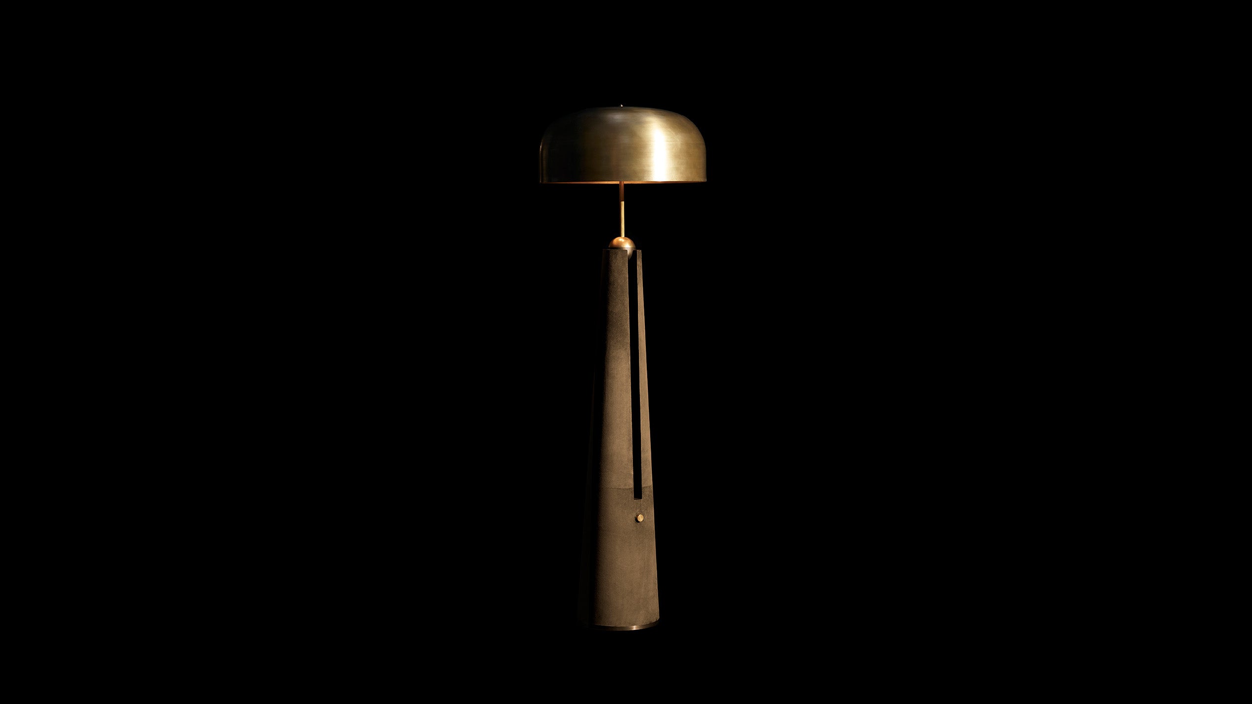 METRONOME floor lamp in Aged Brass finish with Bronze Suede, against a black background. 