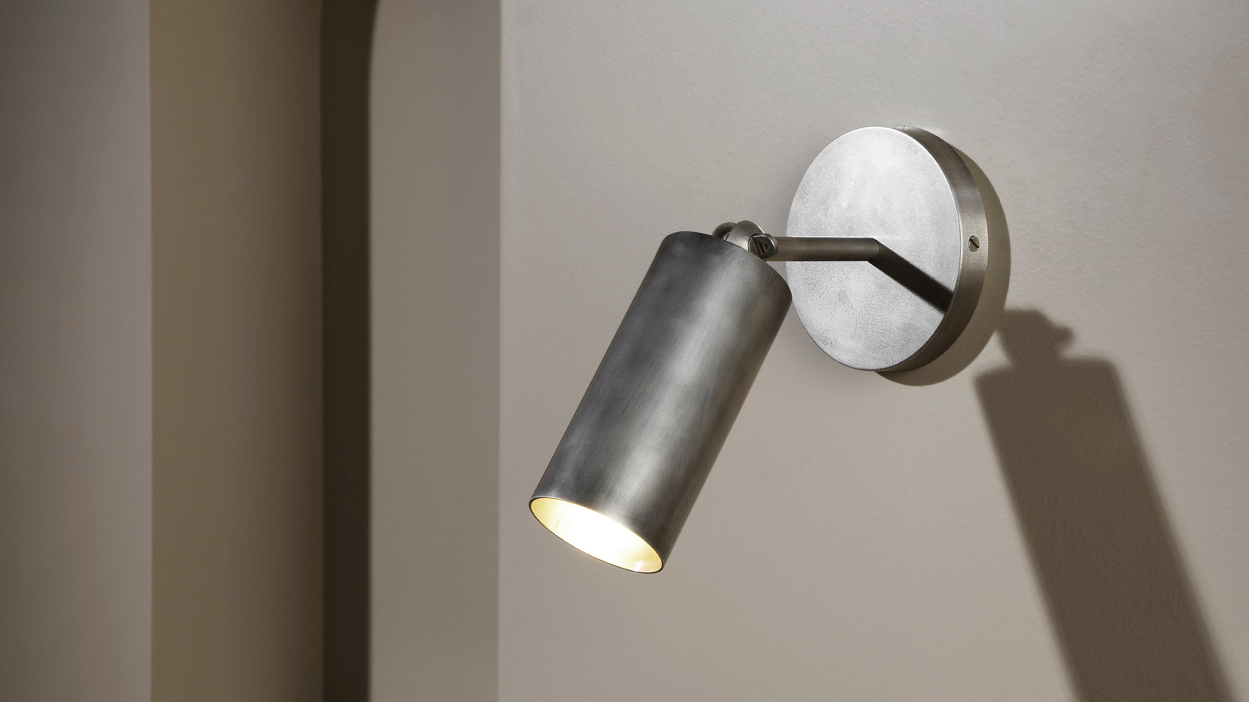 CYLINDER wall sconce in Tarnished Silver finish. 