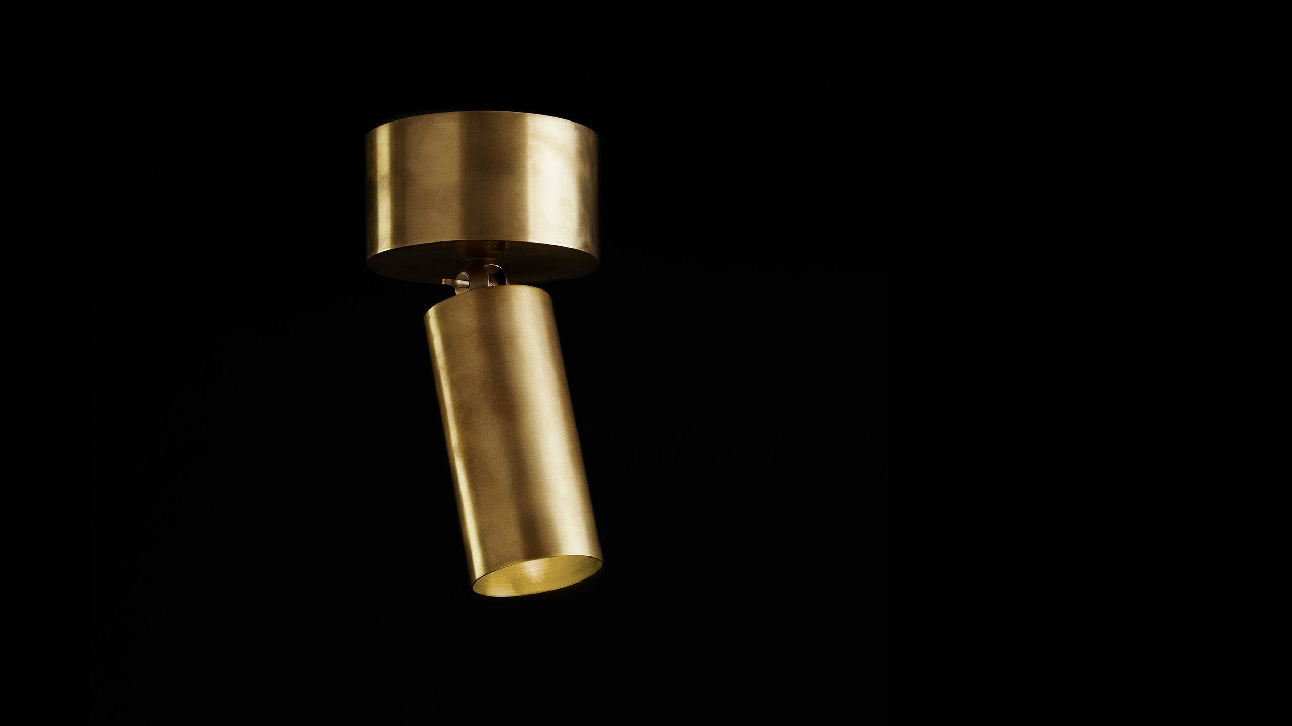 Ceiling mounted CYLINDER spotlight in Aged Brass finish.