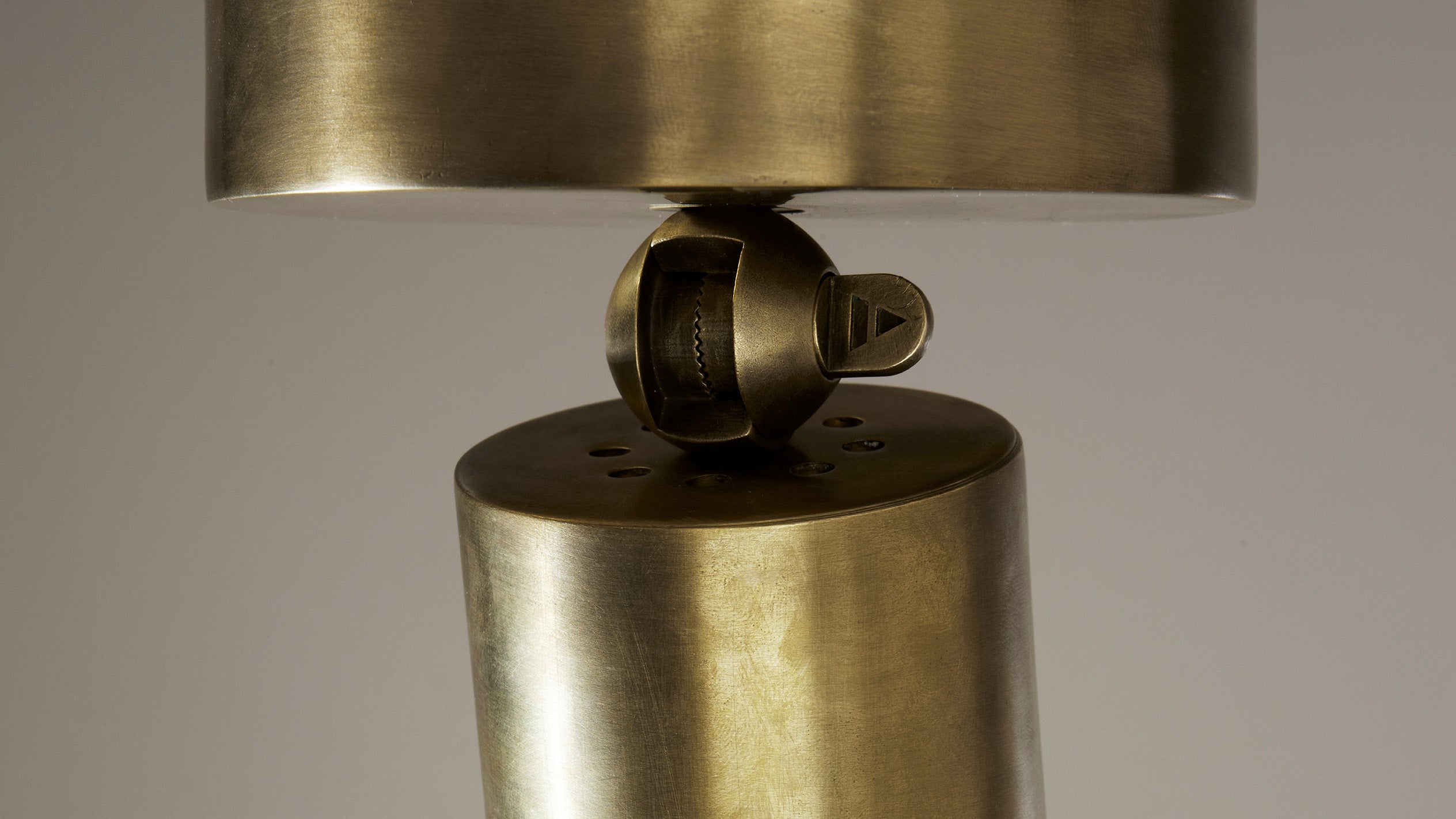 Close up of ceiling mounted CYLINDER spotlight showing details of Aged Brass finish.