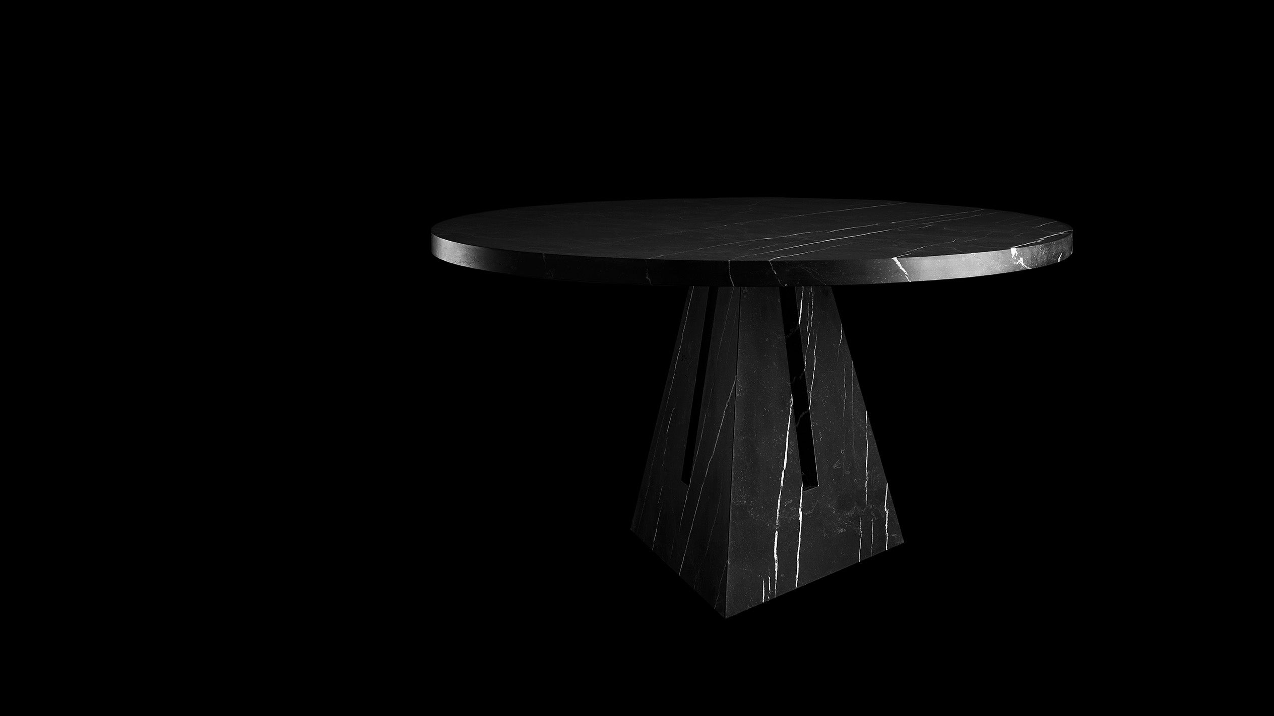 PORTAL circular dining table in Nero Kinitra marble, against a black background. 