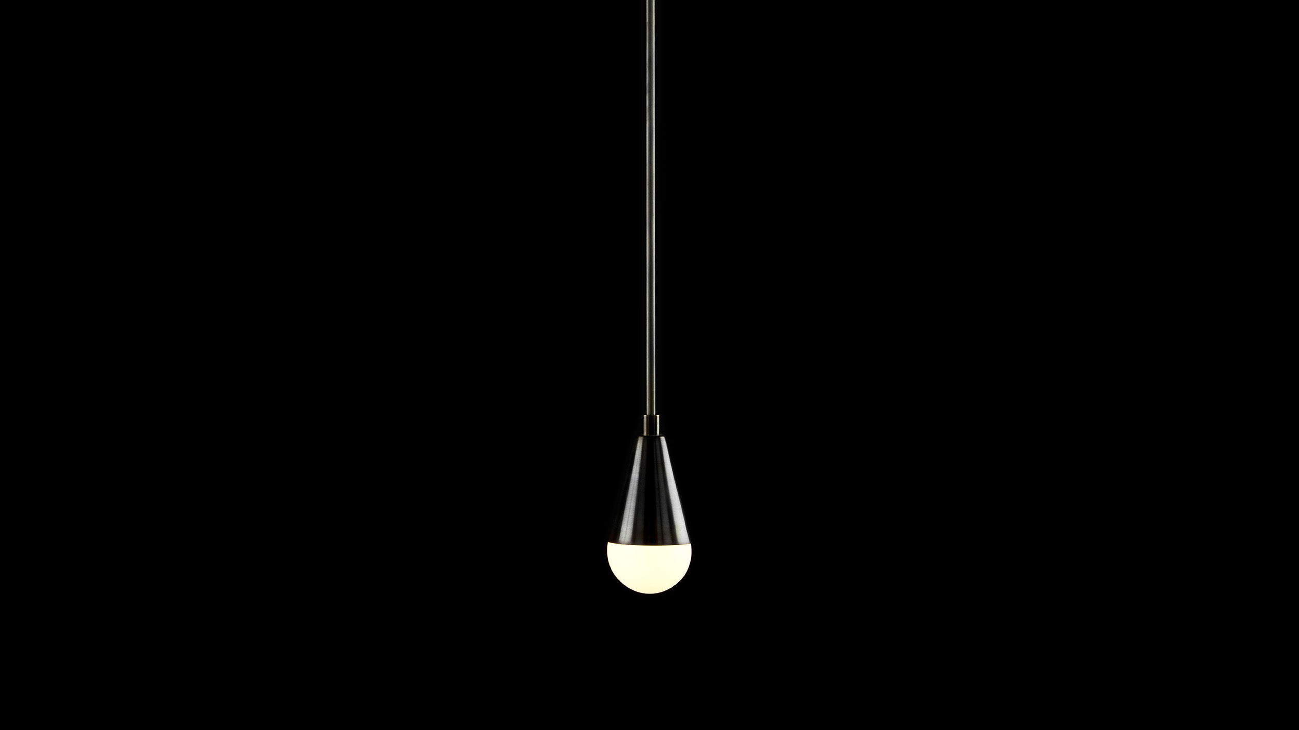 TRIAD : 1 ceiling pendant in Blackened Brass finish, against a black background. 