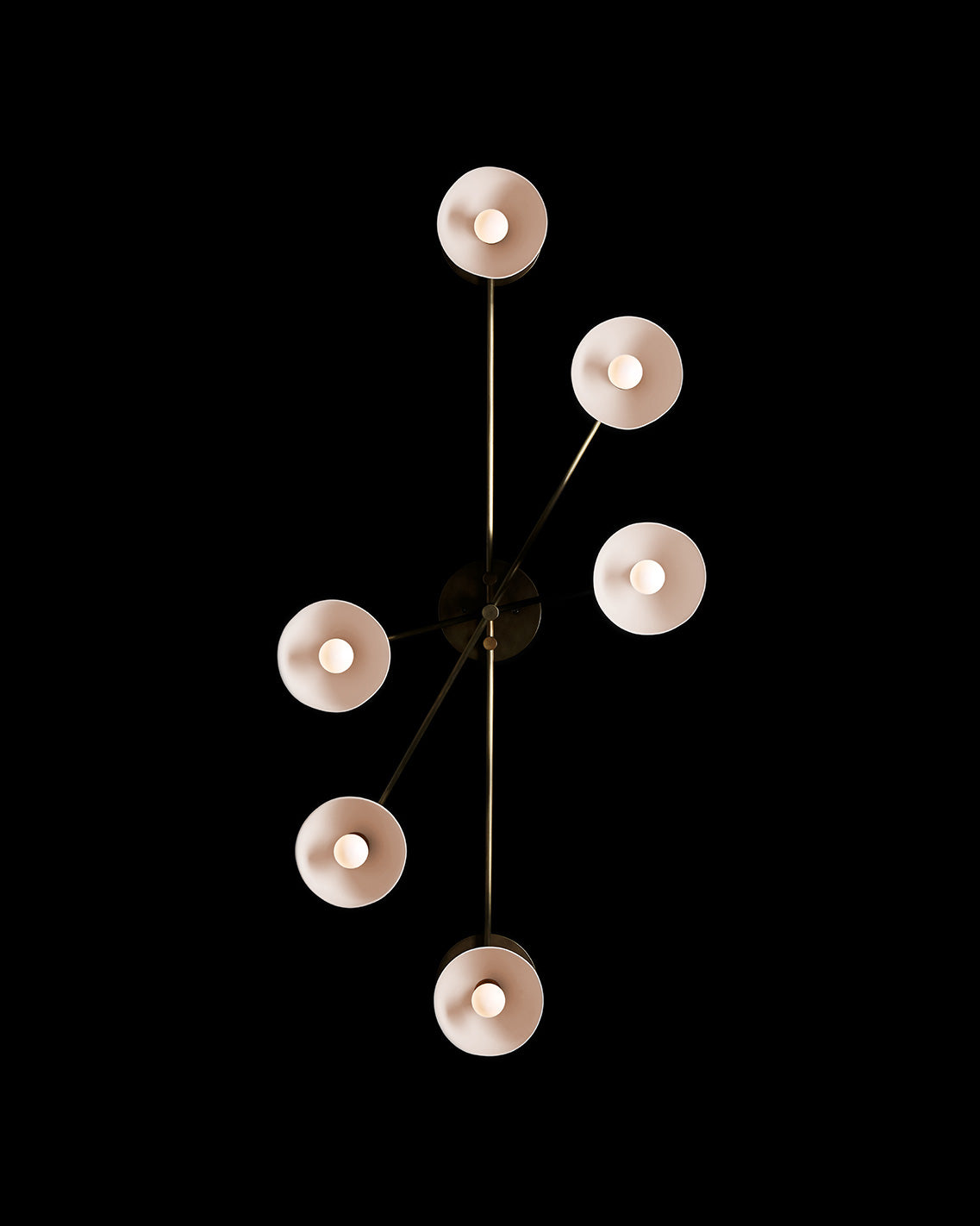 A TRAPEZE : 6 surface light mounted to a black wall.