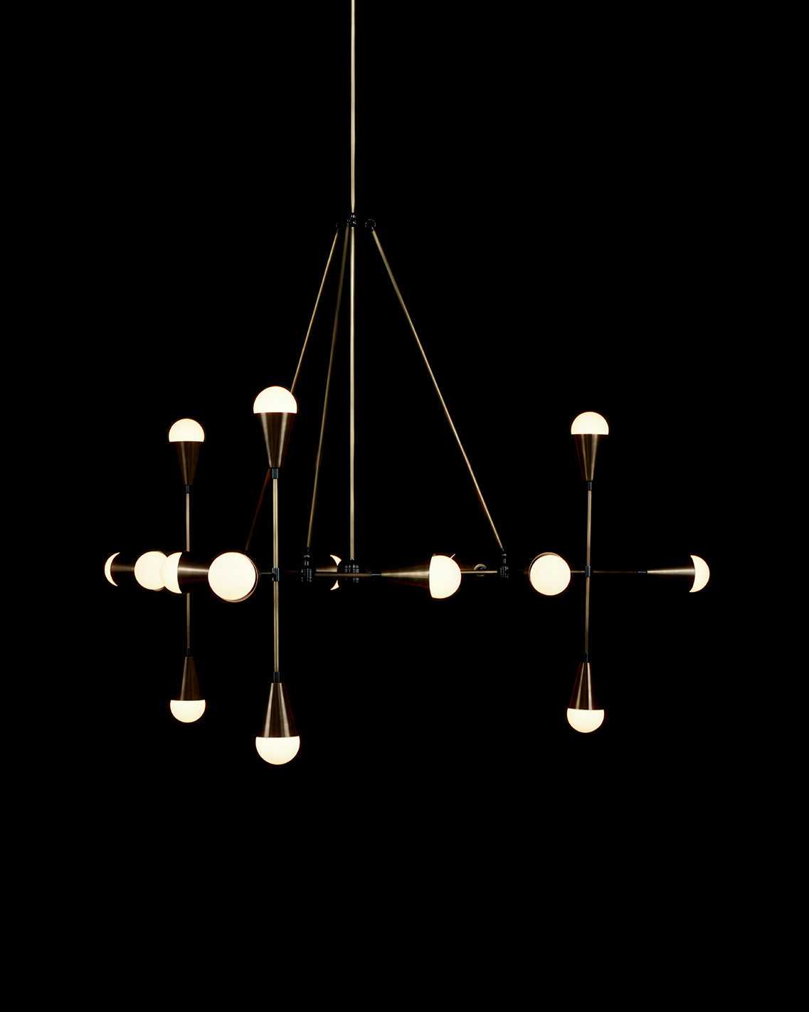 TRIAD : 15 ceiling pendant in Aged Brass and Blackened Brass finish, hanging against a black background. 