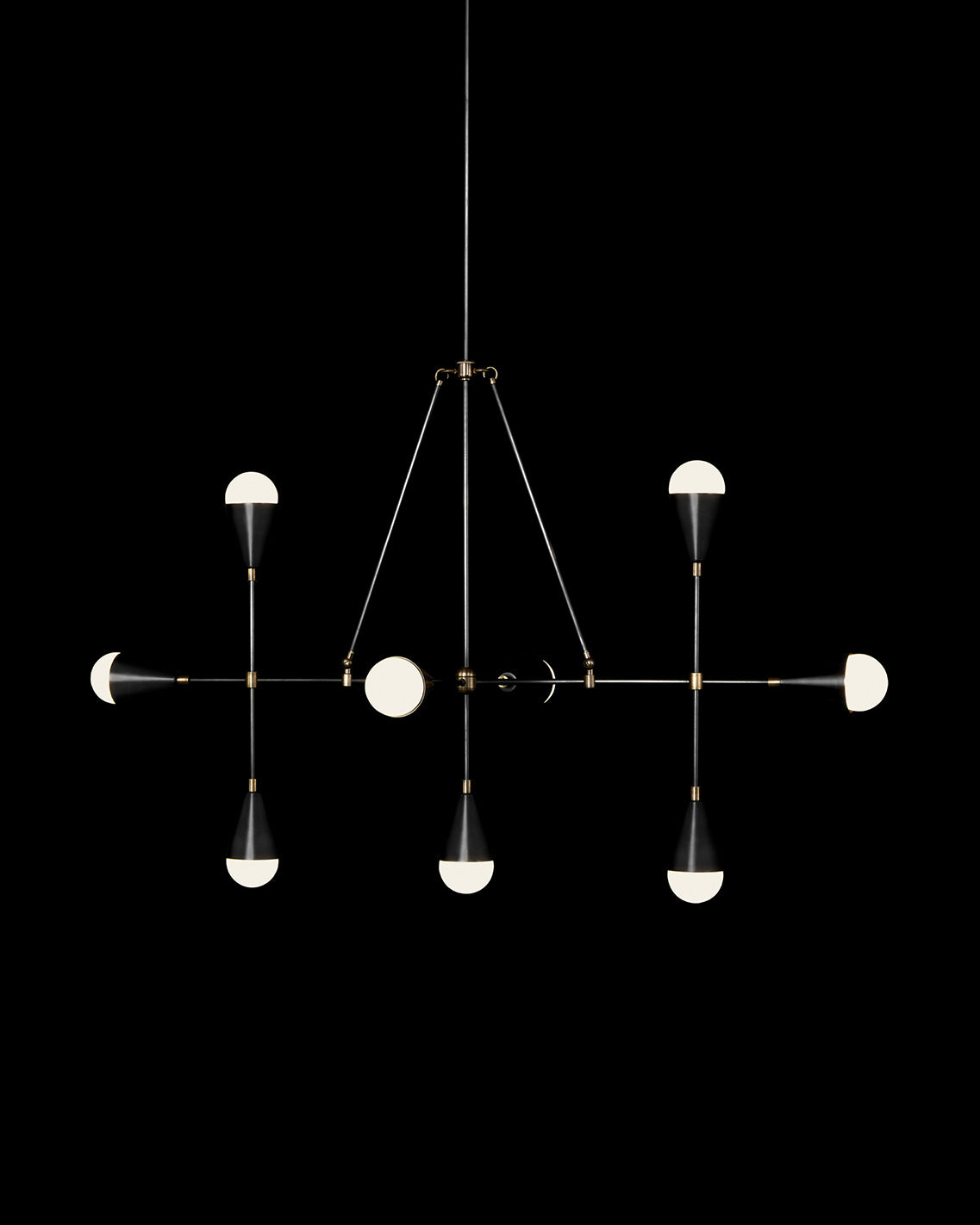 TRIAD : 9 LINEAR ceiling pendant in Blackened Brass and Aged Brass finish, hanging against a black background. 